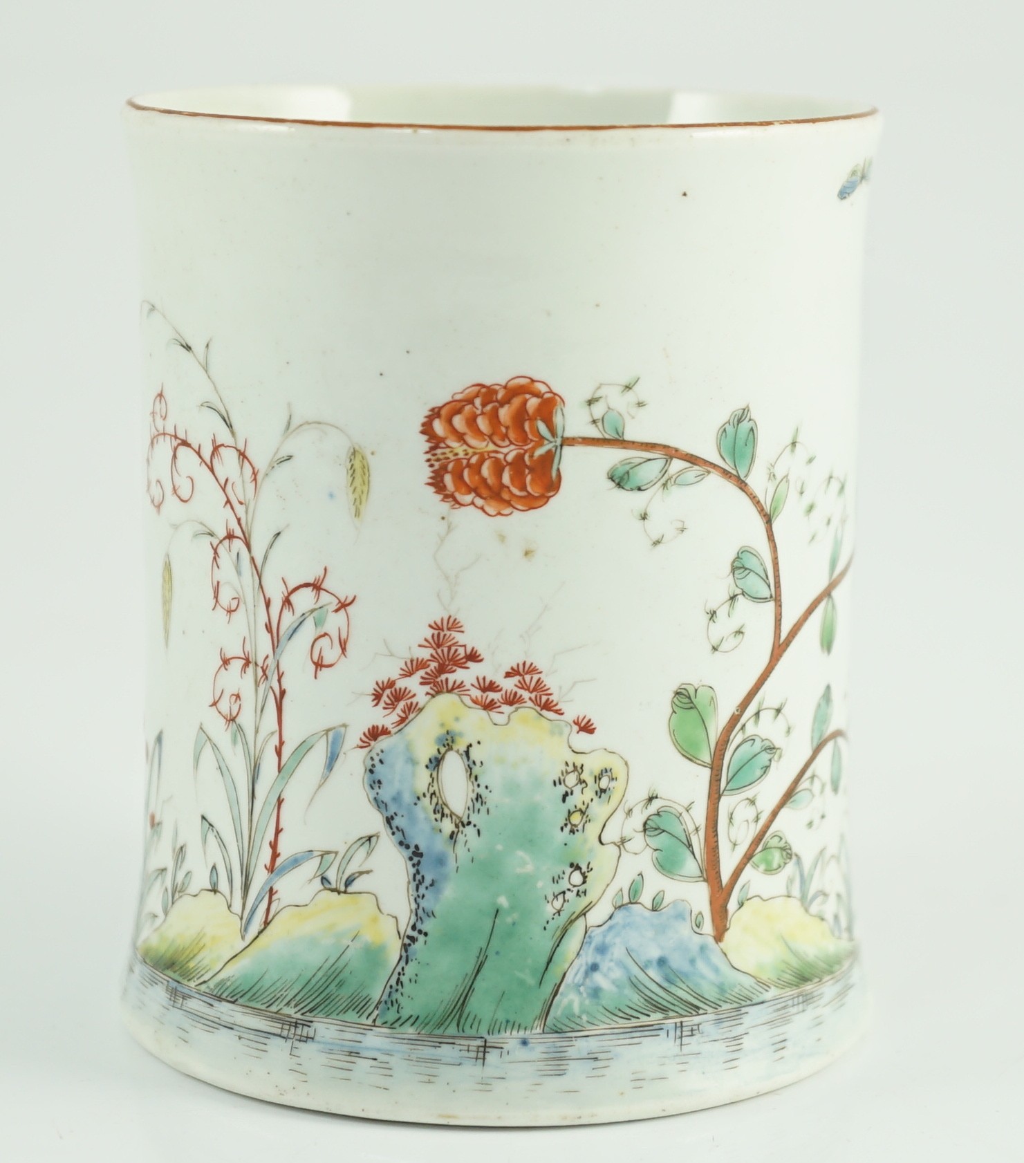 A rare Worcester polychrome 'flower and rockwork' small mug, c.1753-54, 9cm high